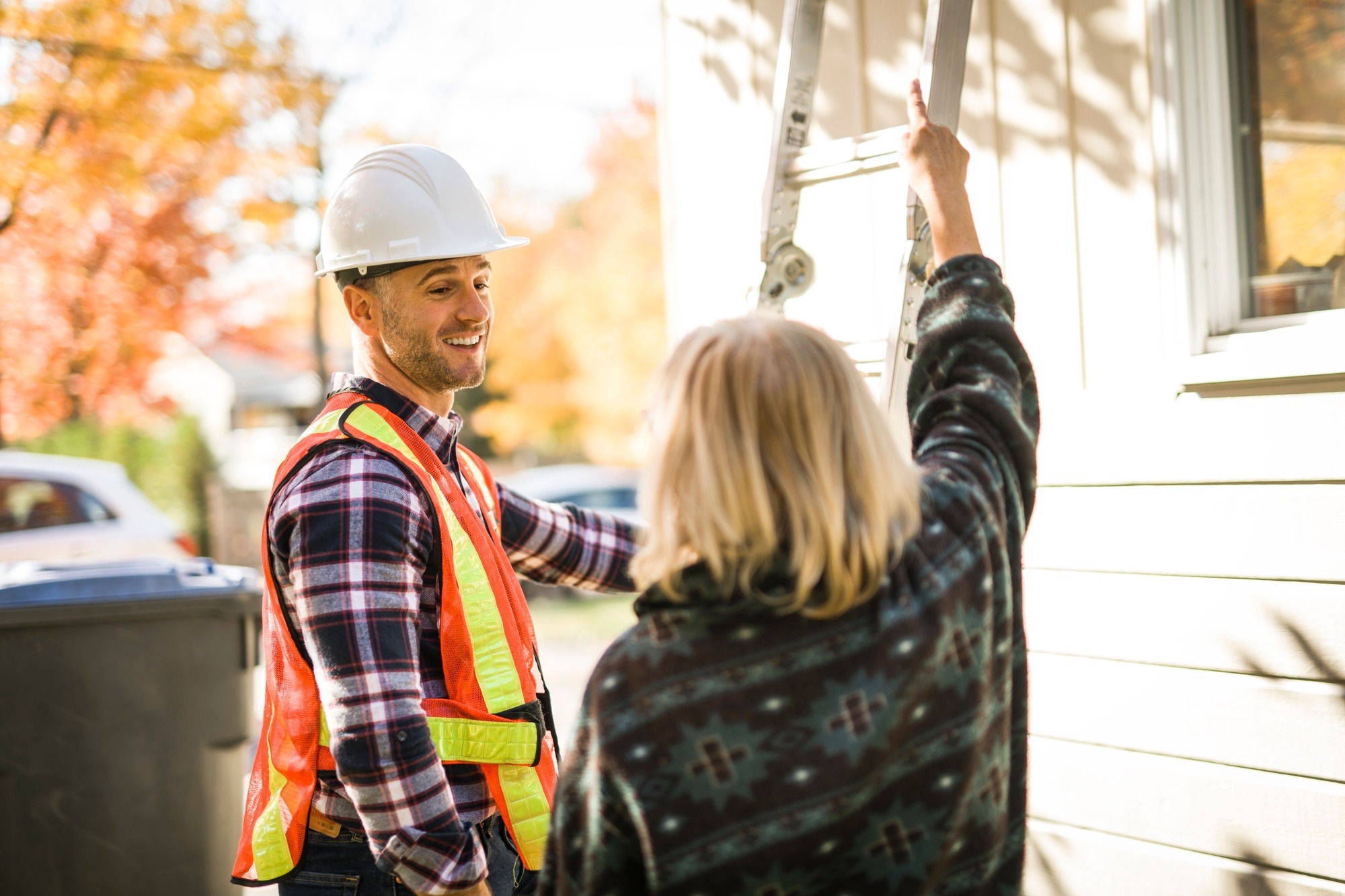 A man with hard hat talking with customer